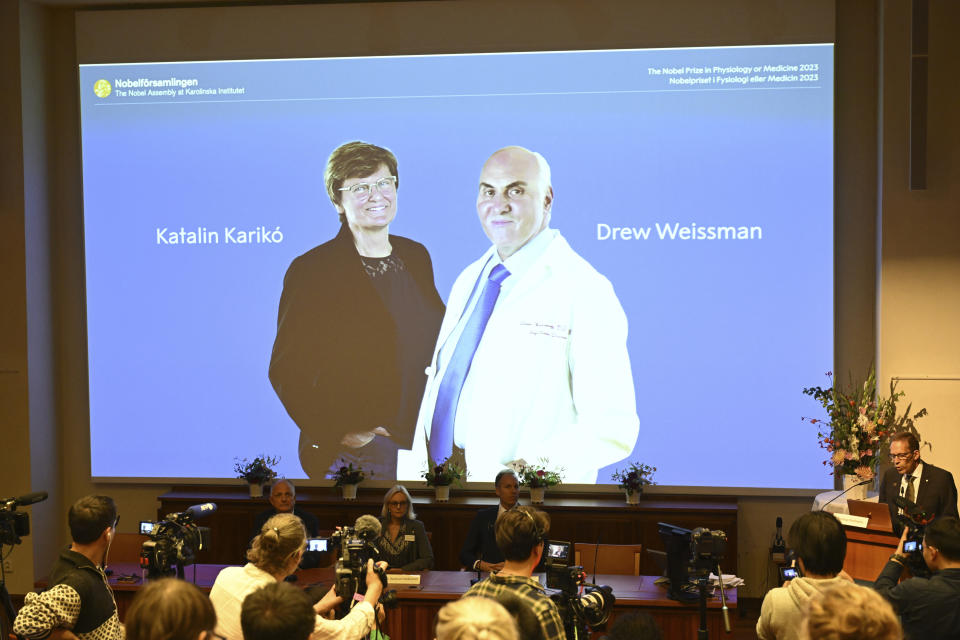 Thomas Perlmann, secretary of the Nobel Assembly, right, announces the winner of the 2023 Nobel Prize in Physiology or Medicine to Katalin Karikó and Drew Weissman, seen on screen, at the Karolinska Institute in Stockholm, Monday Oct. 2, 2023. The Nobel Prize in medicine has been awarded to Katalin Karikó and Drew Weissman for discoveries that enabled the development of effective mRNA vaccines against COVID-19.(Jessica Gow/TT News Agency via AP)