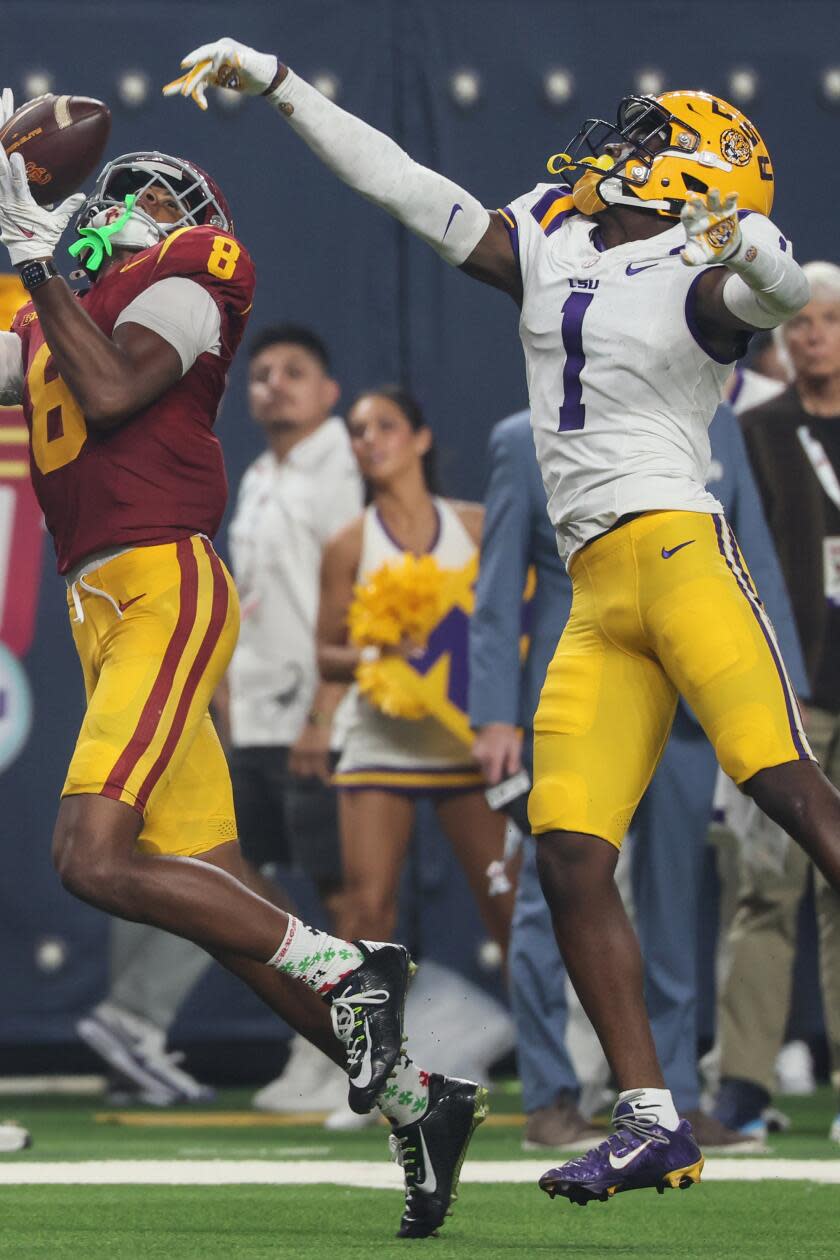 Las Vegas, Nevada, Sunday, September 1, 2024 - USC Trojans wide receiver Ja'Kobi Lane (8) hauls in a touchdown pass over LSU Tigers cornerback Ashton Stamps (1) to pull ahead late in the second half at the Modelo Vegas Kickoff Classic at Allegiant Stadium. (Robert Gauthier/Los Angeles Times)