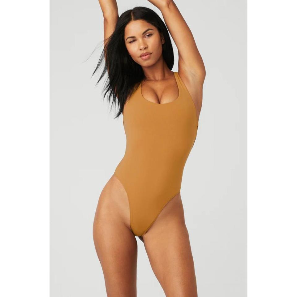 model wearing orange bodysuit