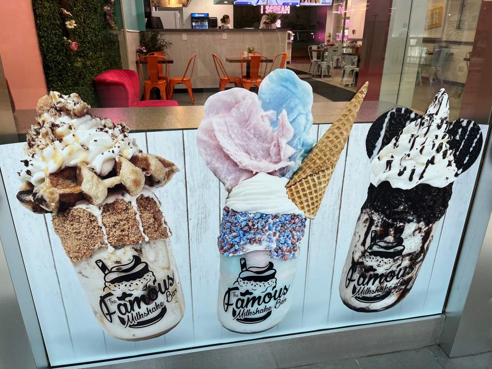 Photos of several of the 12 “over the top” milkshakes served to customers are pictured inside the store on Aug. 30, 2022. The shakes can also be enjoyed in a Mason jar for an additional price.