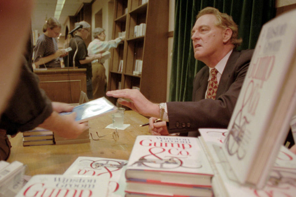 FILE - In this Aug. 21, 1995, file photo, Winston Groom, author of &quot;Forrest Gump,&quot; the book on which the film was based, signs copies of &quot;Gump &amp; Co.,&quot; the sequel to &quot;Forrest Gump&quot;, at a New York City bookstore. Groom, the author of the novel &quot;Forrest Gump&quot; that was made into a six-Oscar winning 1994 movie that became a soaring pop culture hit, has died, an Alabama official close to the writer said Thursday, Sept. 17, 2020. He was 77. (AP Photo/Anders Krusberg, File)