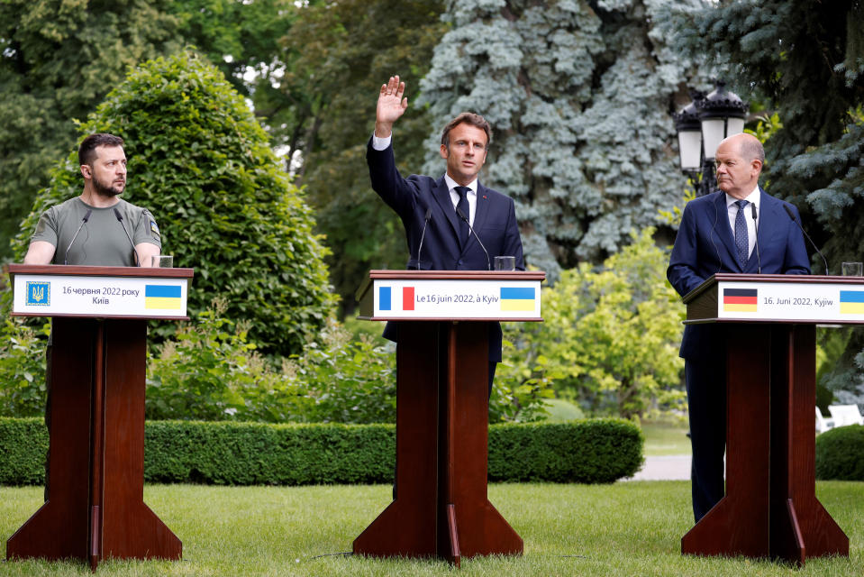 FILE - Ukraine President Volodymyr Zelenskyy, left, France's President Emmanuel Macron, center, and German Chancellor Olaf Scholz attend a press conference in Kyiv, Thursday, June 16, 2022. Emmanuel Macron is badly weakened at home after parliamentary elections cost his party its majority - but his domestic headaches look unlikely to clip his wings on the world stage or threaten his international agenda. (Ludovic Marin, Pool via AP, File)