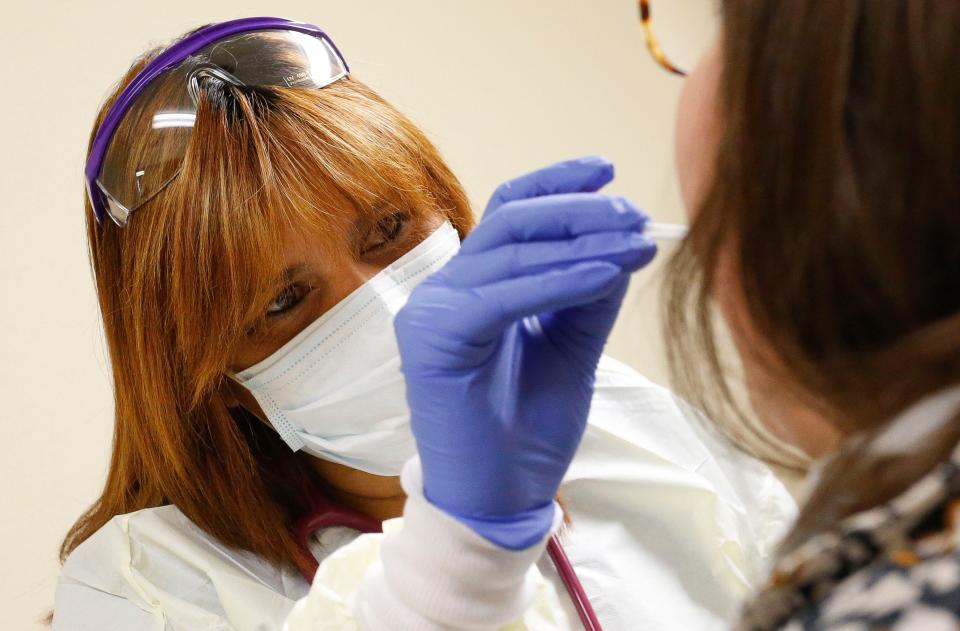 A medical assistant takes a throat swab for COVID-19 testing in Alabama in 2020.