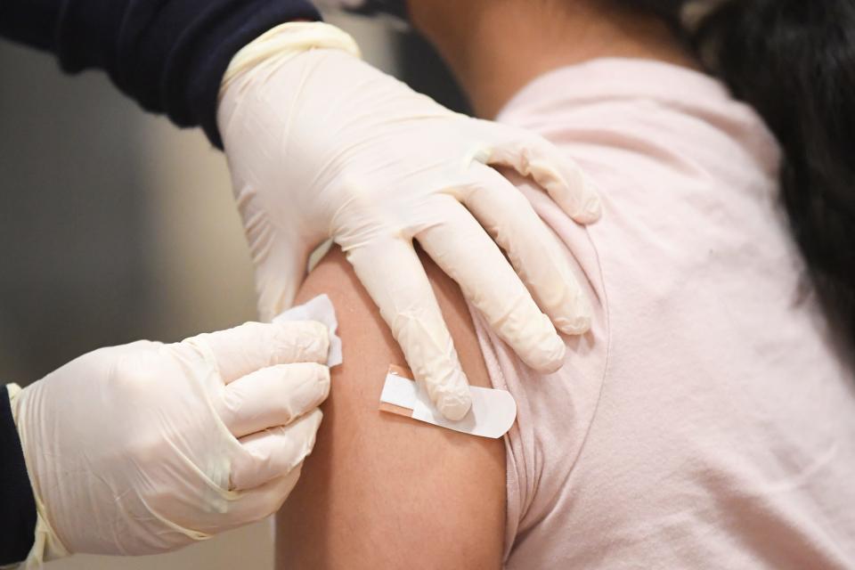 Rhea Soomar, 12, receives a vaccine during a COVID-19 vaccine clinic at the Jacob Building at Chilhowee Park in Knoxville, Tenn. on Saturday, Jan. 8, 2022. The clinic offered vaccines for children and adults alike as well as activities and information booths from community organizations. 