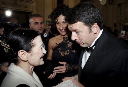 Italian Prime Minister Matteo Renzi (R) and his wife Agense (C) meets former International classic dancer Carla Fracci at the end of the Verdi's Joan of Arc, opening of the 2015-16 opera season at Milan's La Scala opera house, December 7, 2015. REUTERS/Alessandro Garofalo