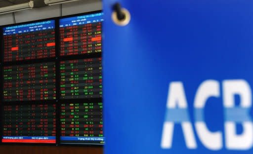 The screen of share prices is seen turning almost red at an Asia Commercial Bank (ACB)'s securities trading floor in Hanoi on August 22, 2012. Vietnam's stock markets have lost nearly $4.0 billion in value after two top bankers were arrested this week in a widening police probe into the banking sector, state media said Friday