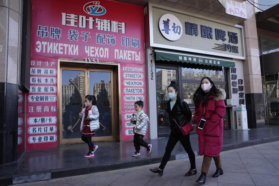 Residents past near shops at a mall also known as Russia Market for its Russian traders on Saturday, Feb. 26, 2022, in Beijing. China is the only friend that might help Russia blunt the impact of economic sanctions over its invasion of Ukraine, but President Xi Jinping's government is giving no sign it might be willing to risk its own access to U.S. and European markets by doing too much. (AP Photo/Ng Han Guan)