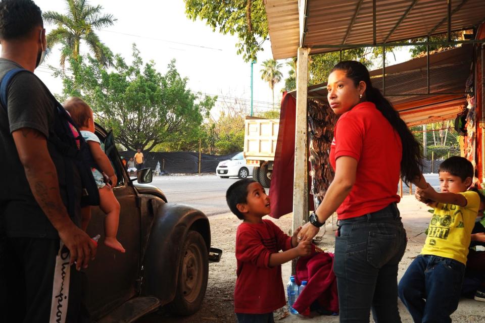 Honduran migrants try to negotiate a ride heading north outside Palenque in southern Mexico.