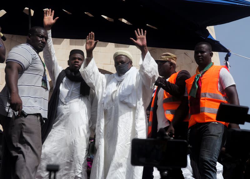 Imam Mahmoud Dicko greets his supporters during a protest demanding the resignation of Mali's President Ibrahim Boubacar Keita at Independence Square in Bamako