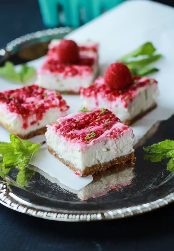 <p>Joyful Healthy Eats</p><p>Cheesecake bars filled with creamy cheesecake goodness, fresh mint and lime juice, then topped with a fresh raspberry compote – only 130 calories! Perfect for summer parties! <a href="http://www.joyfulhealthyeats.com/skinny-raspberry-mojito-cheesecake-bars/" rel="nofollow noopener" target="_blank" data-ylk="slk:Click HERE for recipe;elm:context_link;itc:0;sec:content-canvas" class="link "><strong>Click HERE for recipe</strong></a>.</p>