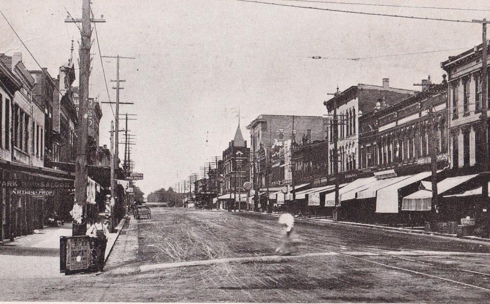 A postcard dated March 6, 1907, depicting Main Street looking north from the intersection with First Street. This view illustrates the condition of Henderson's streets before the city began a major paving program in 1923.