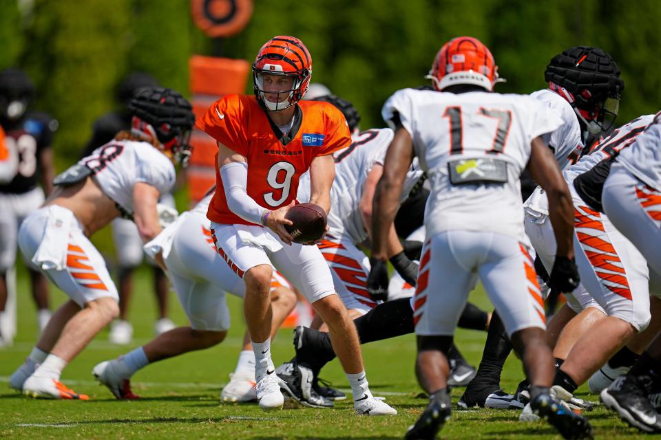 Cincinnati Bengals quarterback Joe Burrow (9) drops back to hand off during a training camp practice at the Paycor Stadium practice fields in downtown Cincinnati on Wednesday, Aug. 17, 2022.