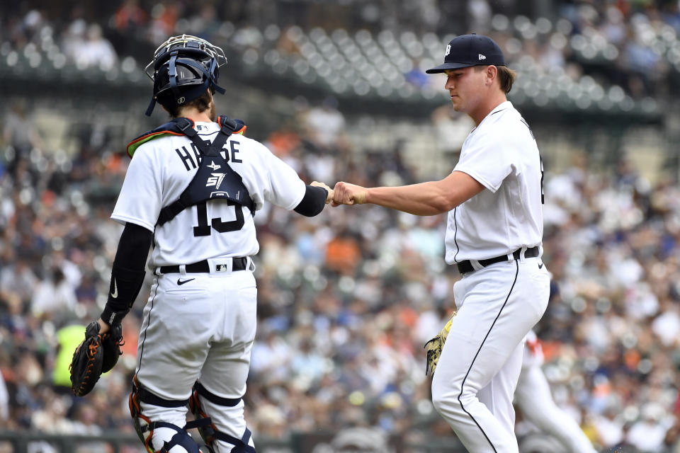 Detroit Tigers catcher Eric Haase, left, and relief pitcher Tyler Holton fist bump at the end of the seventh inning of a baseball game against the Seattle Mariners, Saturday, May 13, 2023, in Detroit. (AP Photo/Jose Juarez)