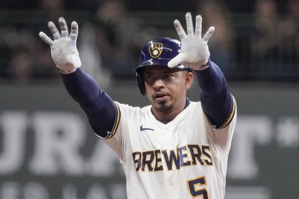 Milwaukee Brewers' Eduardo Escobar reacts after hitting a two-run scoring double during the third inning of a baseball game against the Philadelphia Phillies Tuesday, Sept. 7, 2021, in Milwaukee. (AP Photo/Morry Gash)