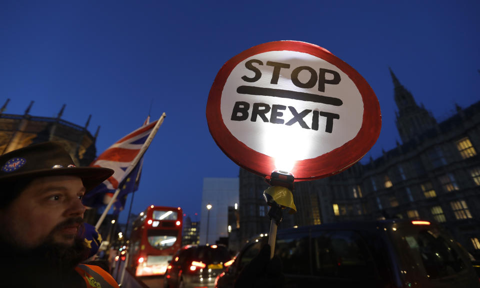 A pro European demonstrator holds a banner near parliament in London, Thursday, Jan. 17, 2019. British Prime Minister Theresa May is reaching out to opposition parties and other lawmakers Thursday in a battle to put Brexit back on track after surviving a no-confidence vote. (AP Photo/Kirsty Wigglesworth)