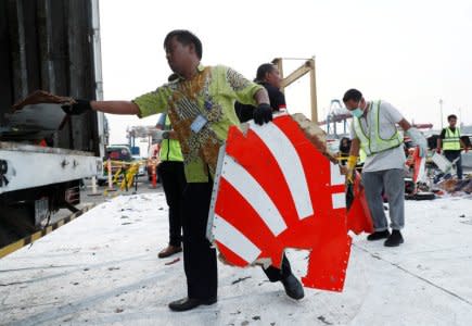 FILE PHOTO: Workers load up recovered debris and belongings believed to be from Lion Air flight JT610 onto a truck at Tanjung Priok port in Jakarta, Indonesia, November 2, 2018. REUTERS/Edgar Su/File Photo