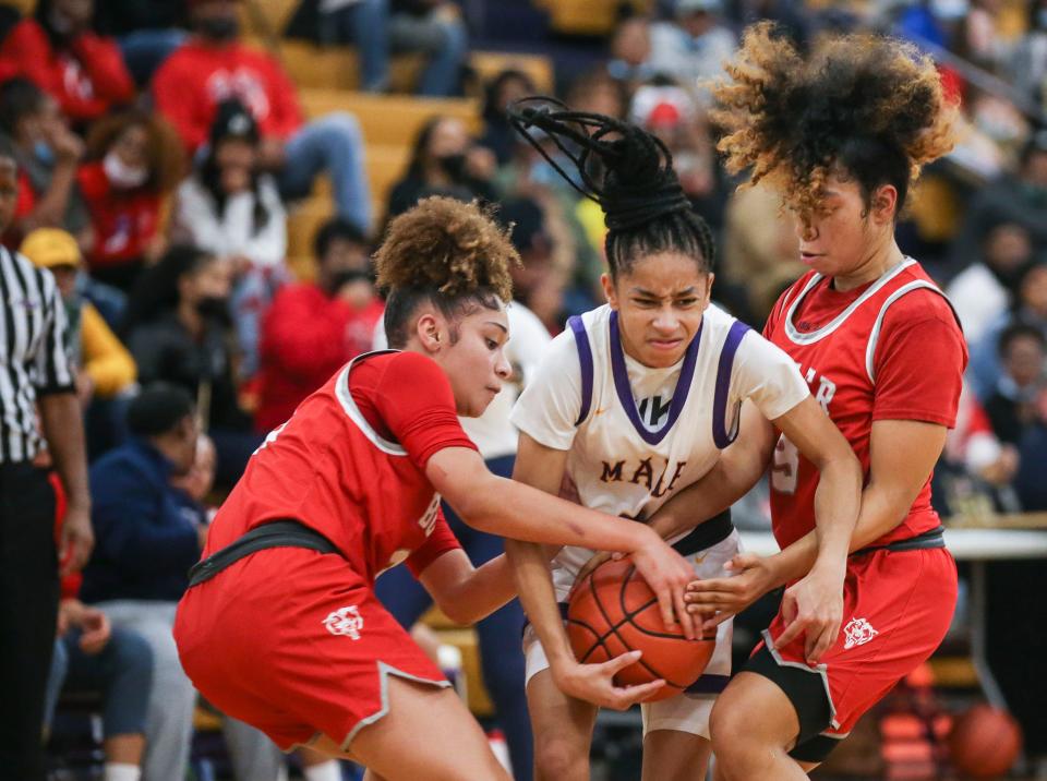 Male's Amirah Jordan is trapped between Butler's Malia Patrick and Emaree Gober in the first half. Jordan finished with 17 points. Dec. 10, 2021