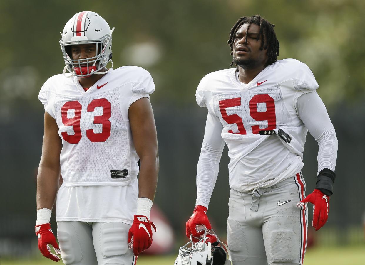 Ohio State Buckeyes defensive linemen Jacolbe Cowan (93) and Darrion Henry-Young (59) during football training camp at the Woody Hayes Athletic Center in Columbus on Tuesday, Aug. 10, 2021. 