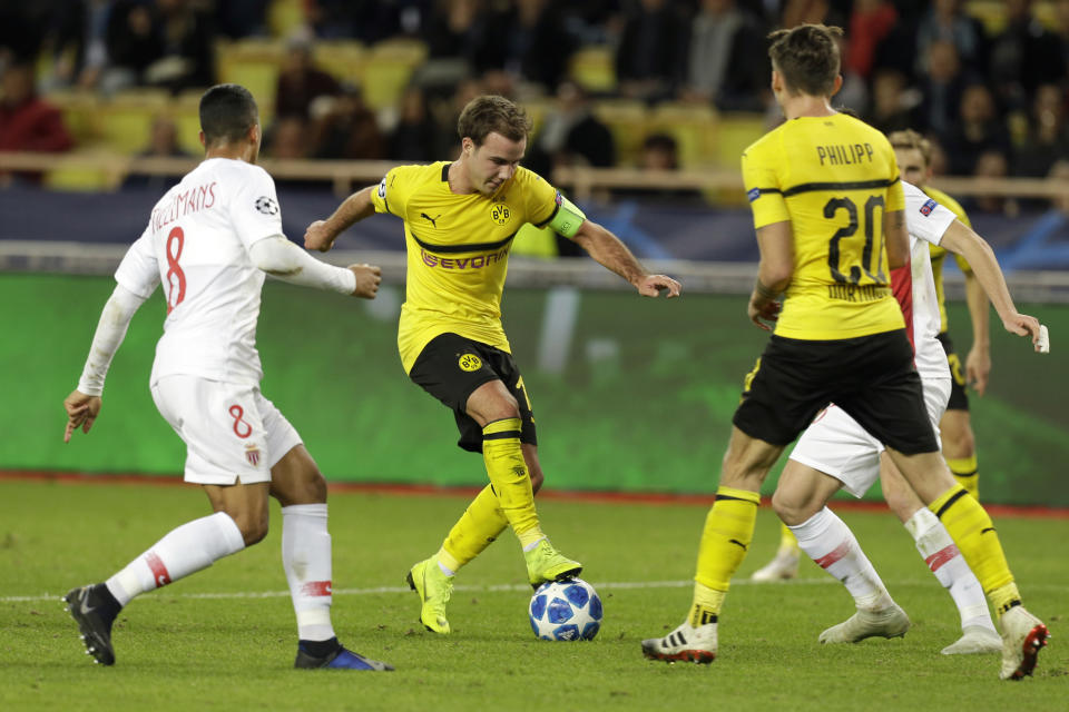 Dortmund's Mario Gotze, second right, controls the ball front of Monaco midfielder Youri Tielemans, left, during the Champions League group A soccer match between AS Monaco and Borussia Dortmund, in Monaco, Tuesday, Dec. 11, 2018. (AP Photo/Claude Paris)