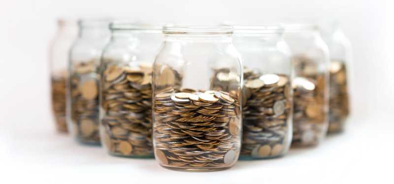 Glass jars filled with coins.