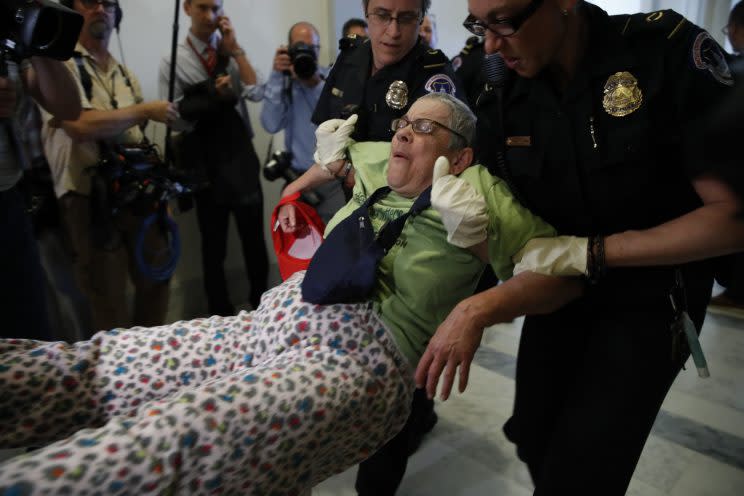 Protesters are removed from outside of Senate Majority Leader Mitch McConnell's office 