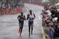 Evans Chebet, of Kenya, left, runs near Gabriel Geay, of Tanzania, right, along the course of the 127th Boston Marathon, Monday, April 17, 2023, in Brookline, Mass. Chebet went on to win the race. (AP Photo/Steven Senne)