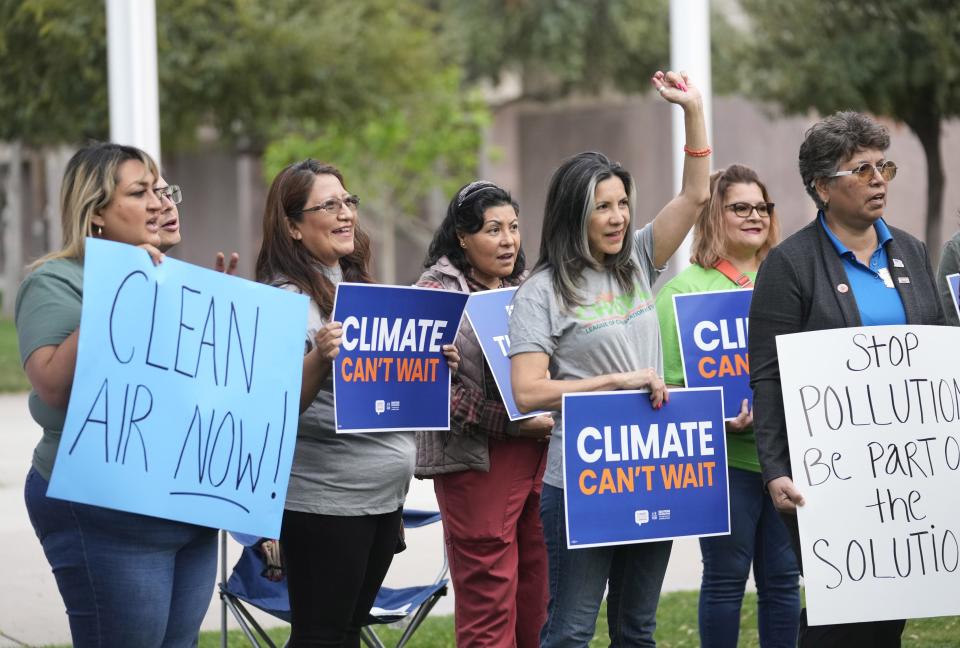 Protesters hold clean air standards signs at the Arizona Capitol in Phoenix on March 20, 2023. Organizers were calling for stronger state protections from air pollution and particulate matter.