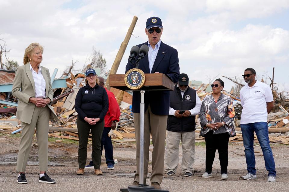 President Joe Biden speaks after surveying the damage in Rolling Fork on Friday, after a deadly tornado and severe storm moved through the area. From left, first lady Jill Biden, FEMA Administrator Deanne Criswell, Biden, Rep. Bennie Thompson, D-Miss., and Housing and Urban Development Secretary Marcia Fudge.