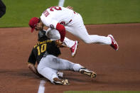 Pittsburgh Pirates' Bryan Reynolds dives safely back to third to avoid the tag from St. Louis Cardinals third baseman Nolan Arenado during the sixth inning of a baseball game Tuesday, May 18, 2021, in St. Louis. (AP Photo/Jeff Roberson)