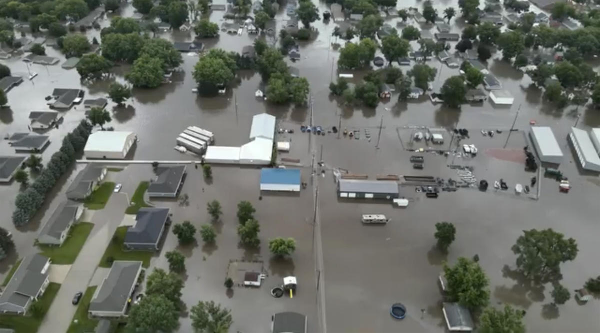 Helicopters scramble to rescue people in flooded Iowa town while much of US toils again in heat