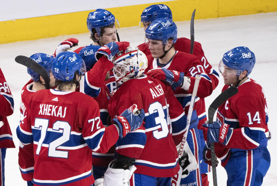 Montreal Canadiens goaltender Jake Allen is congratulated by teammates after stopping the Calgary Flames in the shootout to win 2-1 in an NHL hockey game in Montreal, Monday, Dec. 12, 2022. (Paul Chiasson/The Canadian Press via AP)