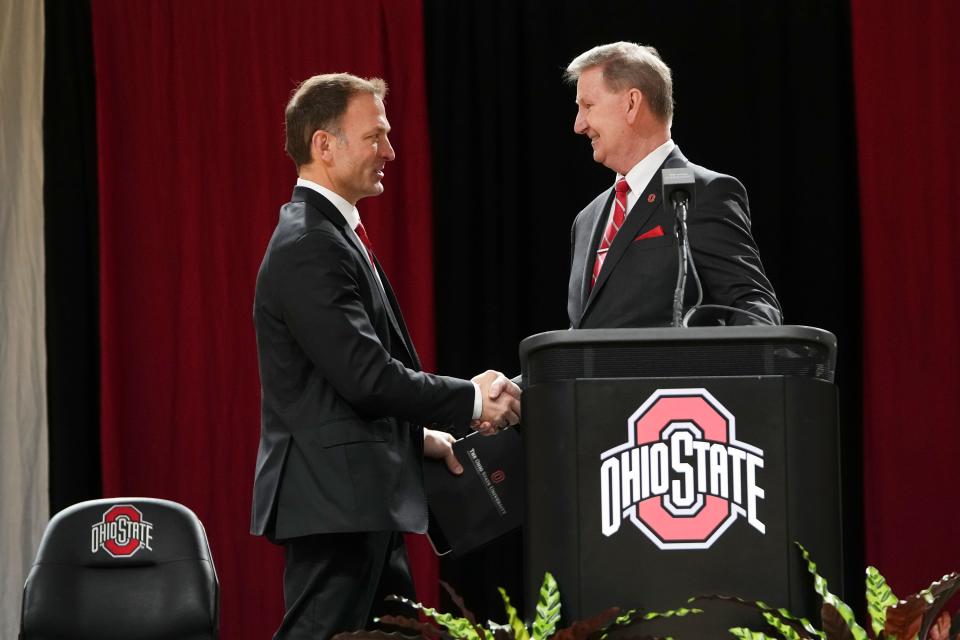 Jan 17, 2024; Columbus, OH, USA; President Ted Carter shakes hands with Ross Bjork during an introductory press conference for Ohio State University’s new athletic director at the Covelli Center.