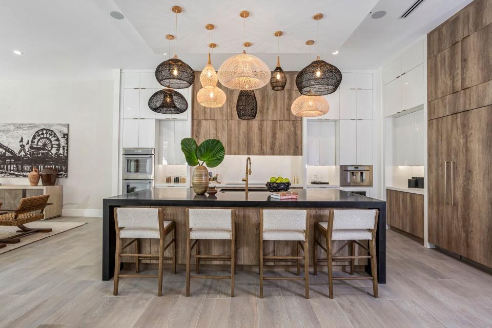 a kitchen with a bar and chairs