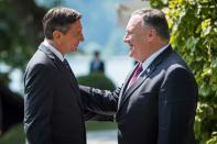 Slovenia's President Borut Pahor, left, welcomes US Secretary of State Mike Pompeo upon his arrival prior to their meeting in Bled, Slovenia, Thursday, Aug. 13, 2020. Pompeo is on a five-day visit to central Europe with a hefty agenda including China's role in 5G network construction. (Jure Makovec/Pool Photo via AP)