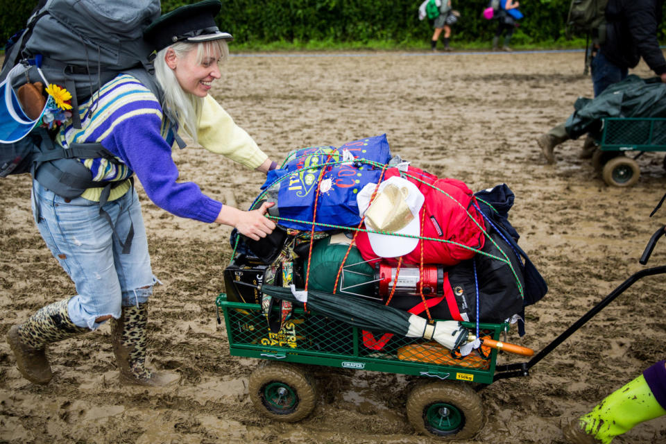 Keep moving: Another Glasto fan makes their way through the sludge. (SWNS)