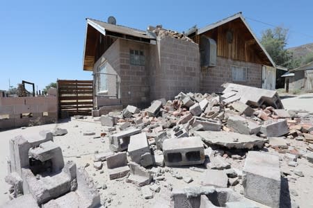 A house is left damaged by an earthquake, triggered by a previous day quake, near the epicenter in Trona, California