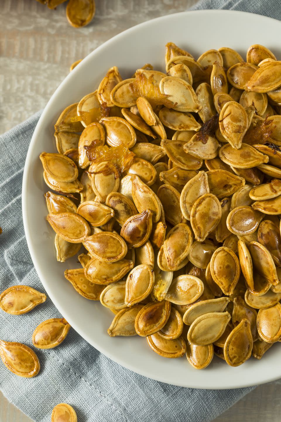 <p>Nuts and seeds make great snacks because they offer healthy fats, which are super satiating. But they also contain protein, which works to keep hunger pangs at bay. Take ever-popular and versatile pumpkin seeds, for example. One ounce contains 8 grams of protein, some iron, and magnesium for under 200 calories.</p><p><strong>Power up your protein: </strong>There’s no limit to what you can do with these crunchy seeds. From homemade granola to pesto, here are seven <a rel="nofollow noopener" href="https://www.prevention.com/food-nutrition/g20481920/7-healthy-pumpkin-seed-recipes/" target="_blank" data-ylk="slk:delicious ways to use up your pumpkin seeds;elm:context_link;itc:0;sec:content-canvas" class="link ">delicious ways to use up your pumpkin seeds</a>.</p>