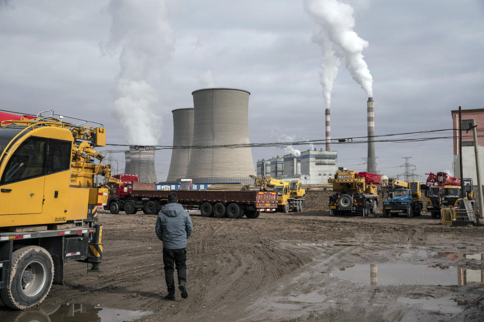 A man walks past a coal-fired power plant in Jiayuguan, Gansu province, China, April 1, 2021. / Credit: Qilai Shen/Bloomberg/Getty