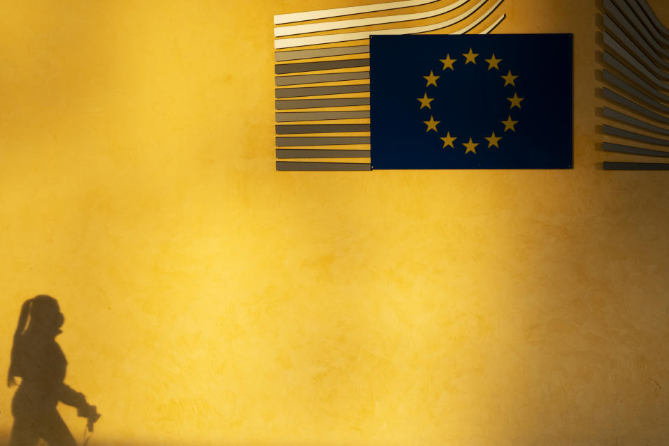 A shadow of a woman is seen next to the European Commission logo at the EU headquarters in Brussels, Friday, Dec. 18, 2020. European Commission's Head of Task Force for Relations with the United Kingdom Michel Barnier said that the bloc and the United Kingdom were starting a "last attempt" to clinch a post-Brexit trade deal, with EU fishing rights in British waters the most notable remaining obstacle to avoid a chaotic and costly changeover on New Year. (AP Photo/Francisco Seco)