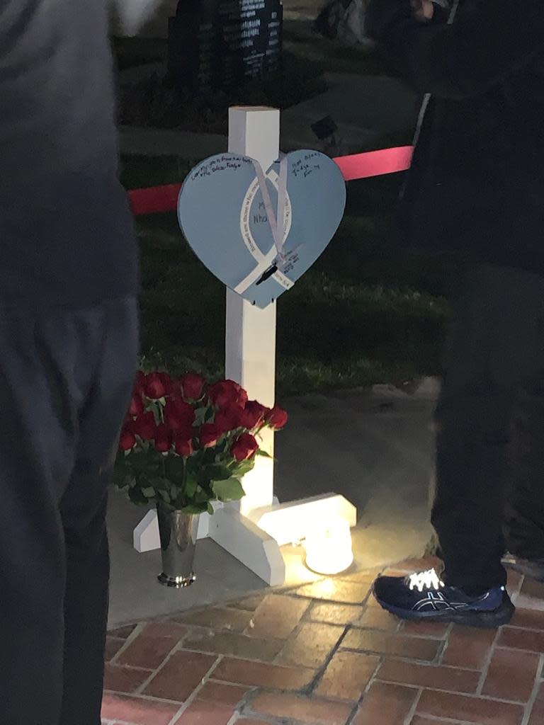 A heart and cross from the Lutheran Church Charities Hearts of Mercy and Compassion, Crosses for Losses Ministry stands at a vigil held Monday night for the victims and families of the Monterey Park mass shooting.