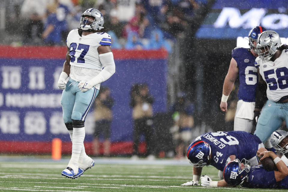 Dallas Cowboys' Osa Odighizuwa, left, celebrates a sack during the second half of an NFL football game against the New York Giants, Sunday, Sept. 10, 2023, in East Rutherford, N.J. (AP Photo/Adam Hunger)