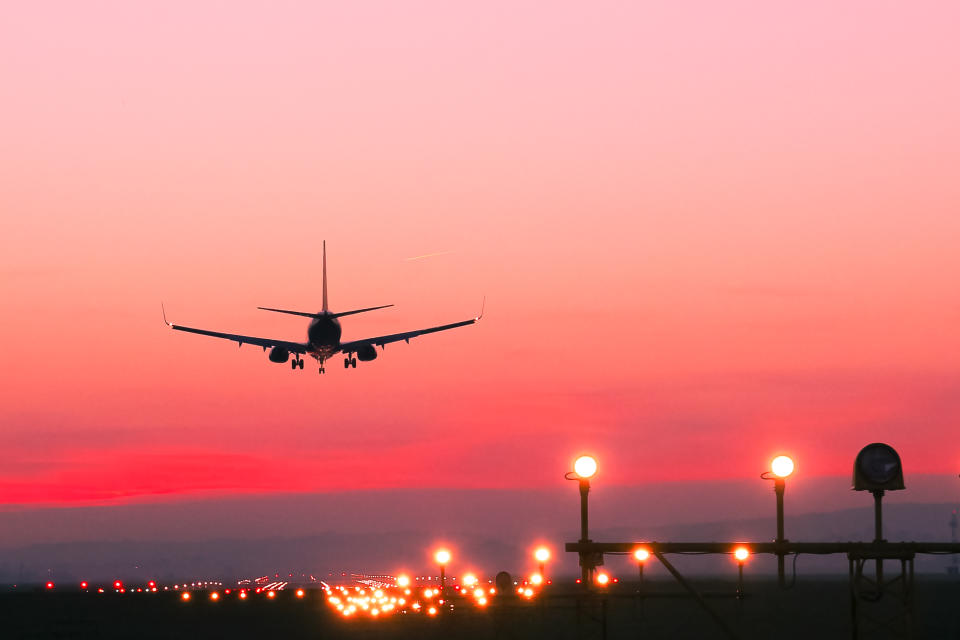 Shot of an airline landing at sunset