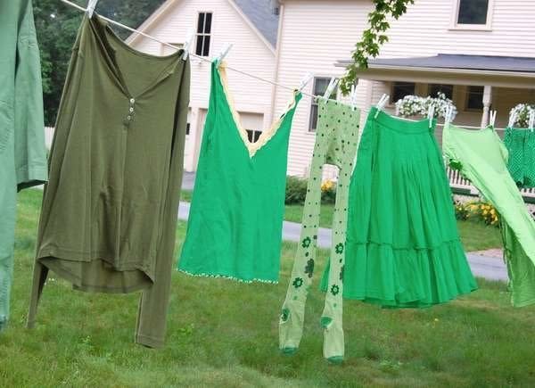 Green clothes drying on an outdoor clothesline