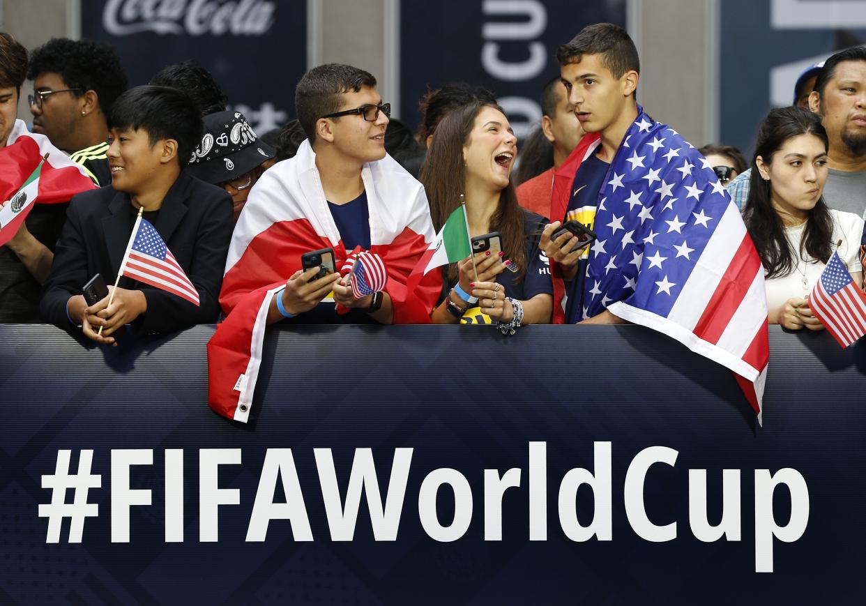 Fans wait along 6th Ave. for FIFA's announcement of the names of the host cities for the 2026 World Cup soccer tournament, Thursday, June 16, 2022, in New York. 