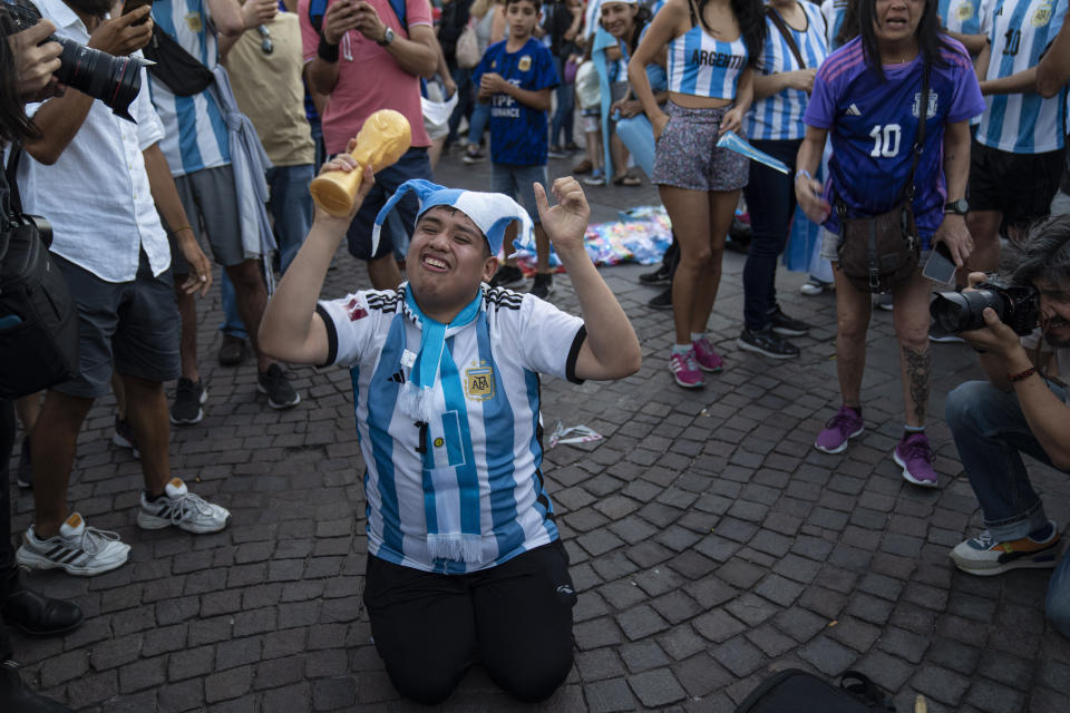 An Argentine soccer fan cheers during a rally in support of the national soccer team, a day ahead of the World Cup final against France, in Buenos Aires, Argentina, Saturday, Dec. 17, 2022.(AP Photo/Rodrigo Abd)