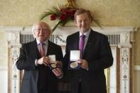 President Michael D. Higgins (L) holds the holds the Seal of Taoiseach as Irish Prime Minister Enda Kenny holds the Seal of Government to office, in Dublin, Ireland May 6, 2016. REUTERS/Clodagh Kilcoyne