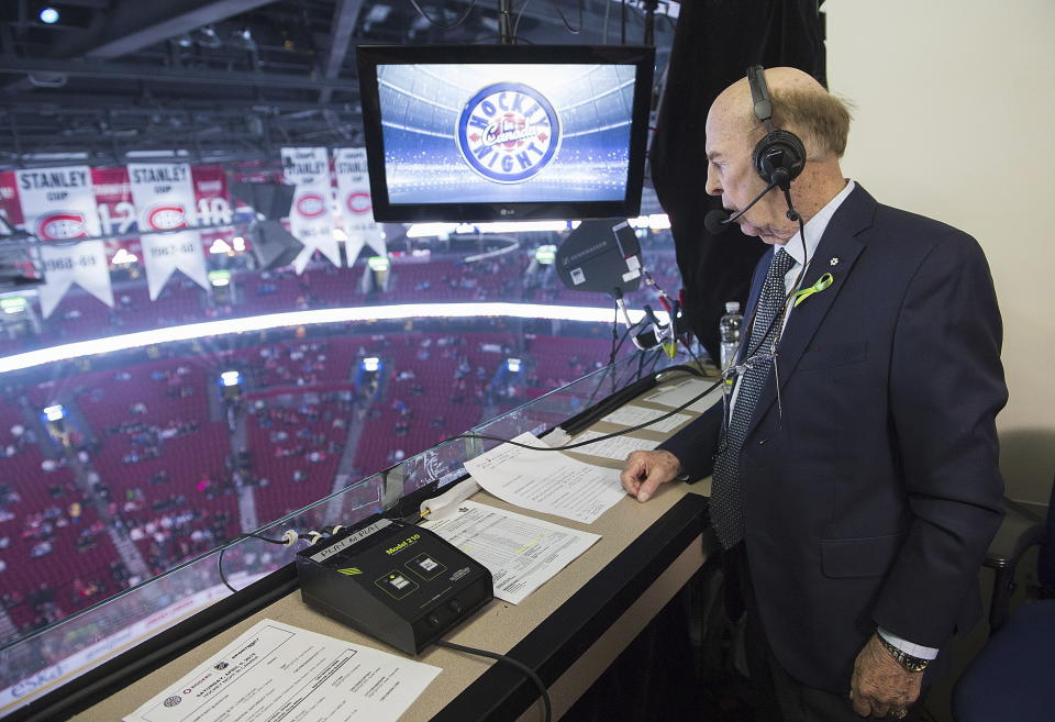 FILE - Broadcaster Bob Cole looks out over the ice prior to calling his last NHL hockey game between the Montreal Canadiens and the Toronto Maple Leafs in Montreal, Saturday, April 6, 2019. Cole, the voice of hockey in Canada for a half-century, has died. He was 90. (Graham Hughes/The Canadian Press via AP, FIle)