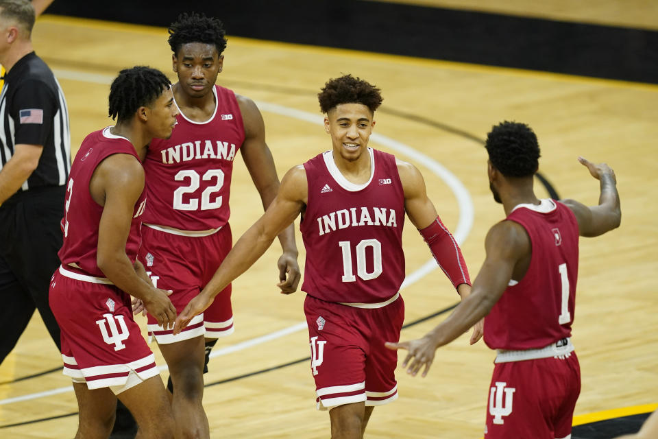 Indiana guard Rob Phinisee (10) celebrates with teammates during the second half of an NCAA college basketball game against Iowa, Thursday, Jan. 21, 2021, in Iowa City, Iowa. Indiana won 81-69. (AP Photo/Charlie Neibergall)