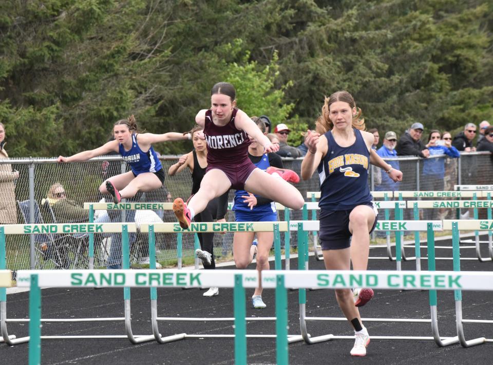 Morenci's Leah Rorick runs in the high hurdles during the Hinsdale Invite at Sand Creek.