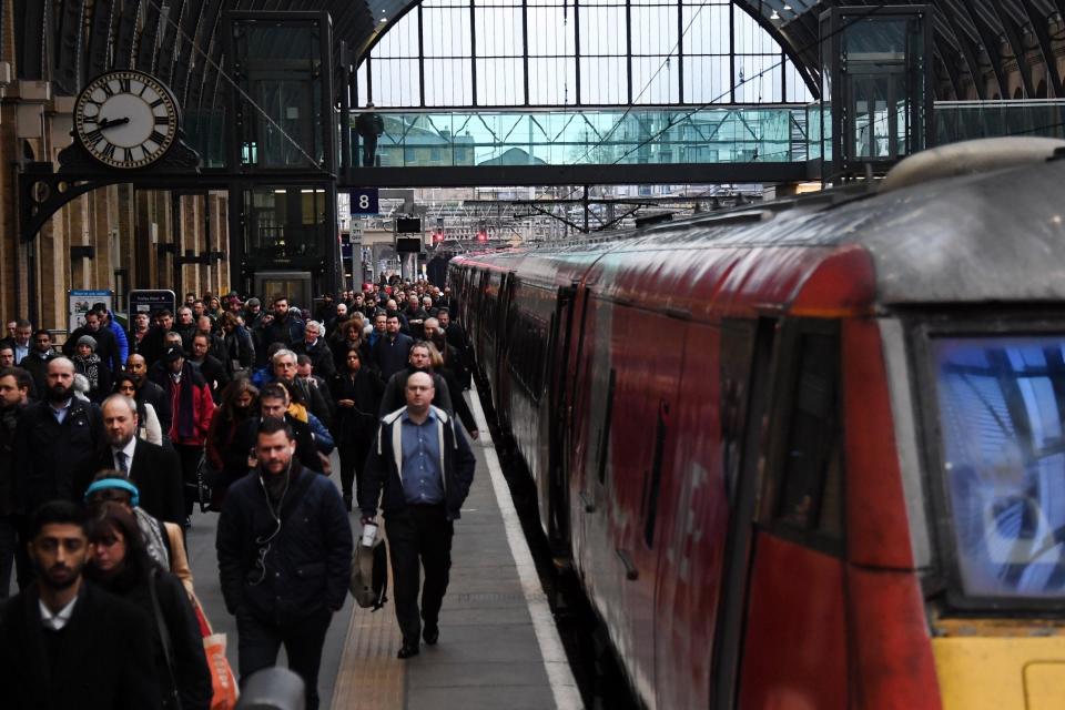 Commuters arrive at King's Cross station in London (EPA)